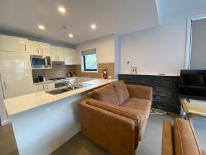 a kitchen with a couch and a kitchen counter at Blues Air 3 - Thredbo in Thredbo
