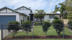 a house with a fence in front of it at Yamba Somerset Cottage in Yamba