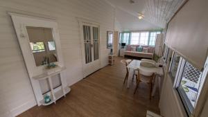 a small room with a table and chairs in a house at Yamba Somerset Cottage in Yamba +14 photos