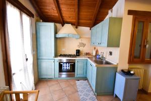 cocina con armarios azules y fogones en Casa Valery, en Lingueglietta