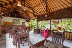 a dining room with tables and chairs in a restaurant at Crystal Bay Villa in Nusa Penida