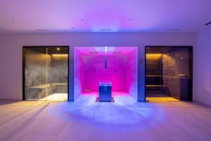 a room with pink lights and a trash can at Hotel Continental in Santa Margherita Ligure