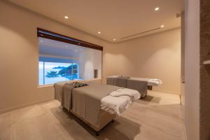 a hospital room with two beds and a window at Hotel Continental in Santa Margherita Ligure