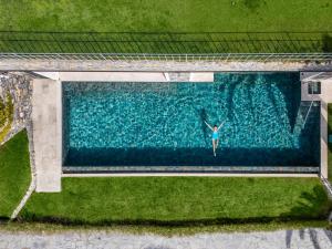 an overhead view of a woman swimming in a pool at Hotel Continental in Santa Margherita Ligure