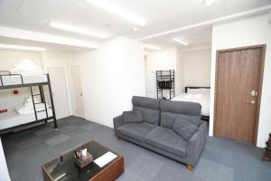a living room with a couch and a bed at SOKOResort Asakusa in Tokyo