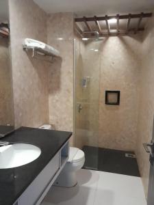 a bathroom with a shower and a toilet and a sink at d'JHIA HOTEL in Nagoya