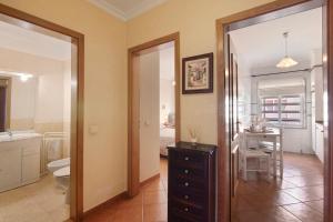 a bathroom with a sink and a toilet and a table at Mar Salgado Beach Apartment in Armação de Pêra +22 photos