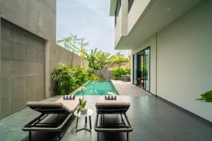 an external view of a house with a swimming pool at The Line Villas Canggu in Canggu