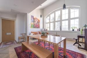 a living room with a table and a couch at Stunning Loft with Water View & Free Garage Parking in Kuopio