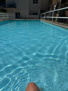 a person swimming in a pool of blue water at White House in Piódão