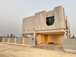 a building with a window on the side of it at Reniva Pool Villa cha-am in Ban Bo Prakhon