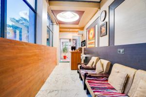 a waiting room with a row of chairs in a building at Super Hotel O JLN Marg Malviya Nagar Formerly Hotel Braj Haveli in Jaipur