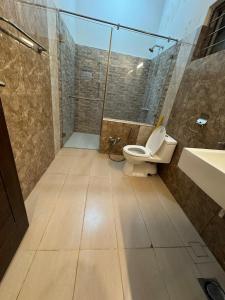 a bathroom with a toilet and a sink at Dream Inn Guest House Islamabad in Islamabad