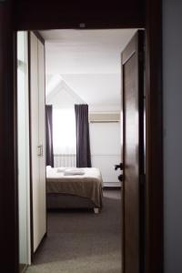 Postel nebo postele na pokoji v ubytování Hotel Tiski Cvet