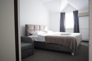 Postel nebo postele na pokoji v ubytování Hotel Tiski Cvet