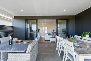 a dining room with a blue table and white chairs at Shell Cove Serenity by Links Golf Course & Marina in Dunmore