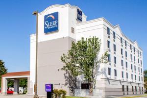 a white building with a pepsi sign on it at Sleep Inn & Suites Metairie - New Orleans West in Metairie