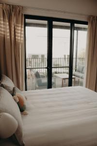 une chambre avec un lit et une vue sur un balcon dans l'établissement Dudley Villa, à Evans Head