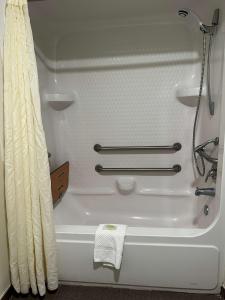 a white bath tub in a bathroom with a shower at Sleep Inn & Suites Pineville - Alexandria in Pineville