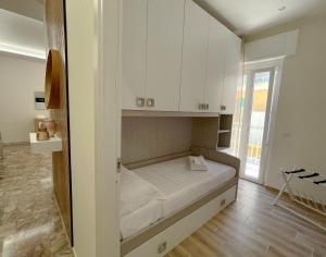 a bedroom with a bed with white cabinets at SIS HOUSE Apartment - Deluxe Apartment in Anzio City Center, 100m from the Sea in Anzio