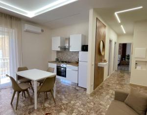 a kitchen and living room with a table and chairs at SIS HOUSE Apartment - Deluxe Apartment in Anzio City Center, 100m from the Sea in Anzio