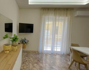 a living room with a table and a window at SIS HOUSE Apartment - Deluxe Apartment in Anzio City Center, 100m from the Sea in Anzio