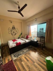 a bedroom with a bed and a ceiling fan at Hotel Fewa Lake View in Pokhara