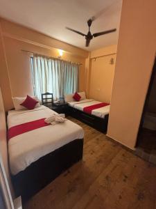 a hotel room with two beds and a ceiling at Hotel Fewa Lake View in Pokhara