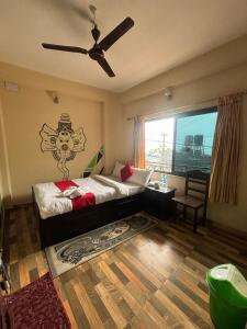 a bedroom with a bed and a ceiling fan at Hotel Fewa Lake View in Pokhara