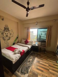 a bedroom with two beds and a ceiling fan at Hotel Fewa Lake View in Pokhara