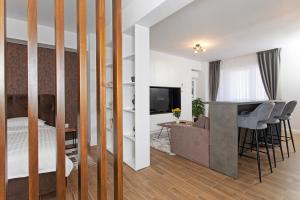 a bedroom with a bed and a living room at Panoramic Studio Oradea 2 in Oradea