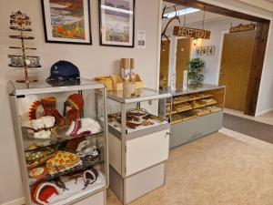 a bakery with a display case filled with lots of pastries at Kuttainen Lodge in Karesuando