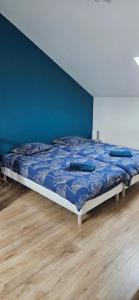 a bed in a bedroom with a blue wall at Au séchoir à Tabac in Bergerac +42 photos