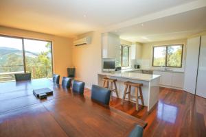 a large living room with a table and chairs at Kangaroo Lodge in Bright