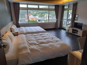 Postel nebo postele na pokoji v ubytování Ci Meng Rou Resort Villa