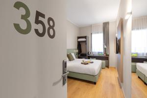 Postel nebo postele na pokoji v ubytování Energy Park Hotel