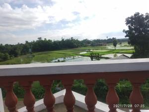 a view from a balcony of a golf course at Udita Homestay Prayas in Shānti Niketan