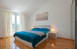 a white bedroom with a bed and a window at Villa Drazana - Makarska by Villas Guide in Perići +26 photos