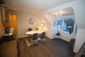 a dining room with a table and a window at Beautify Refurbished Large 3 Bed Terrace in Hawick +13 photos
