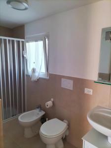 a bathroom with a toilet and a sink at La Casina di Nonna Altea in Massa