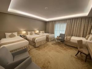 a hotel room with three beds and a window at Finda Hotel in Medina +29 photos