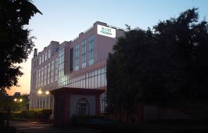 a building with a sign on the top of it at Nest By TreeHouse Bhiwadi in Bhiwadi
