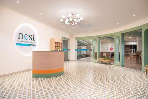 an empty lobby with a nost sign and chairs at Nest By TreeHouse Bhiwadi in Bhiwadi