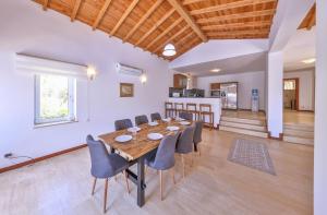 a dining room with a wooden table and chairs at Villa Nane in Kaş