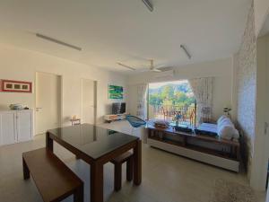 a living room with a couch and a table at By The Sea Suite,Batu Ferringhi in Batu Ferringhi
