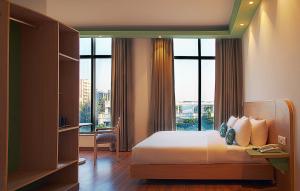 a bedroom with a bed with a large window at Nest By TreeHouse Bhiwadi in Bhiwadi +13 photos