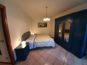 a bedroom with a bed and a dresser at Casa della Nonna 2 in Gargnano