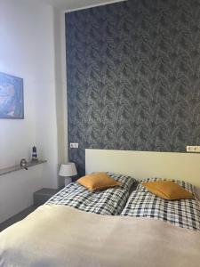 a bedroom with a bed with two pillows on it at Ferienwohnung Holtz 7 in Mesekenhagen