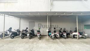 a group of motorcycles parked in a garage at Ruumu Eden Guesthouse in Cimanggis