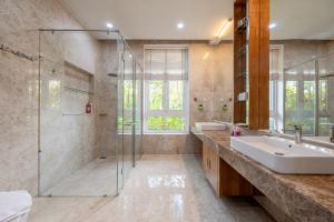 a bathroom with a glass shower and a sink at Thao Dien Serenity Villa in Ho Chi Minh City +133 photos